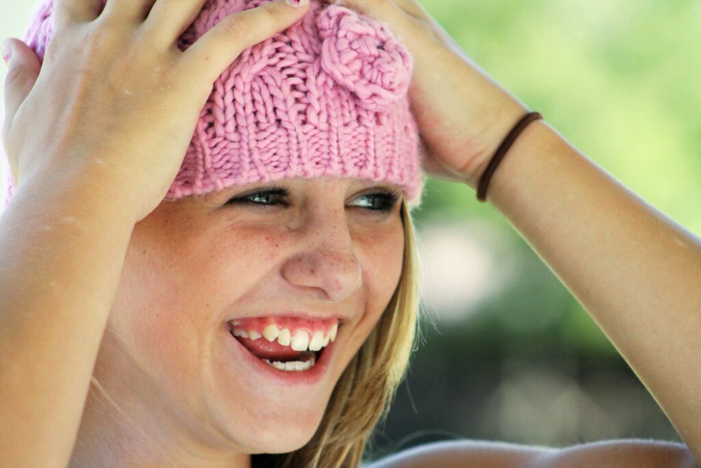A girl in a pink hat, rested after sleep apnea treatment for children in Boulder.