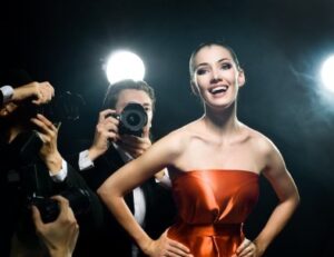 A young woman smiling in front of photographers after getting porcelain veneers in Lafayette.